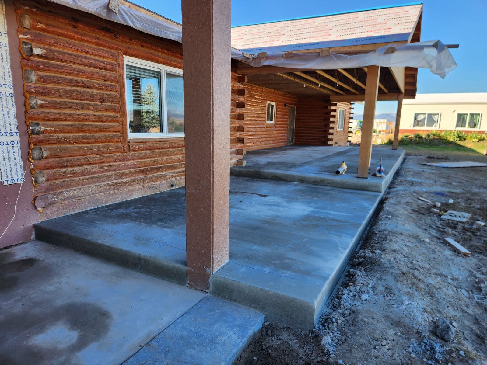 Covered patio & entry step — new pour by Montara Forge
